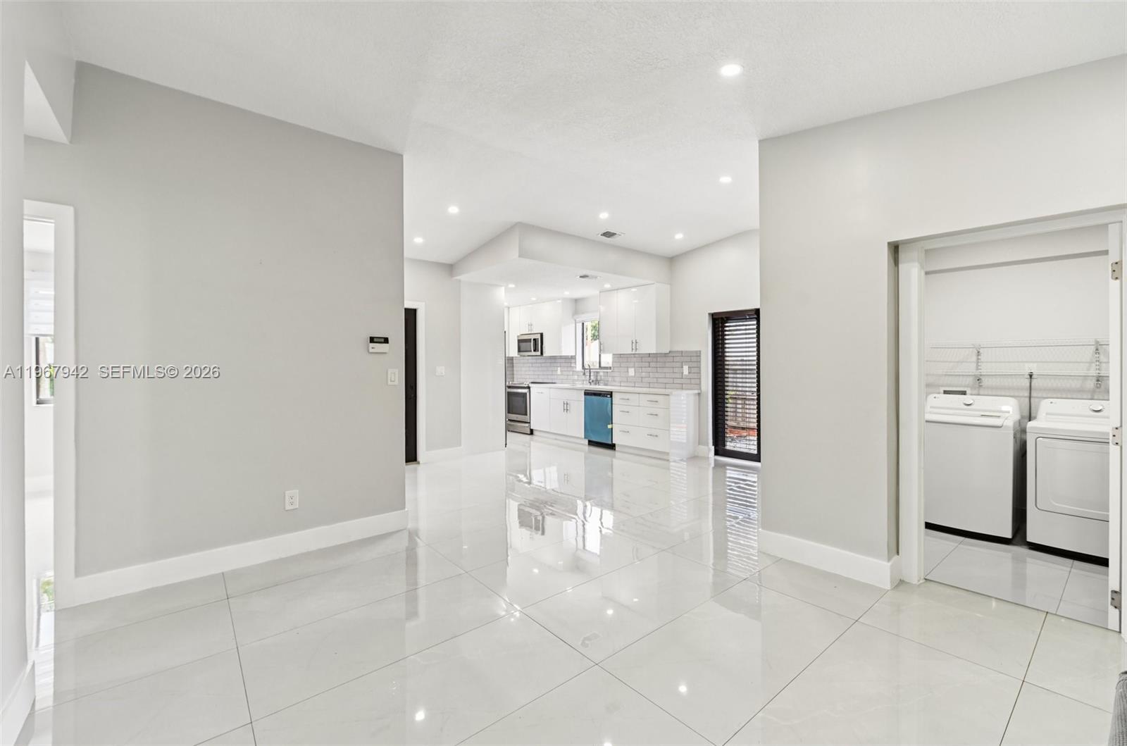 12237 Southwest 193rd Street Miami, FL 33177 - Photo 10 of 41 a view of a kitchen with refrigerator and microwave
