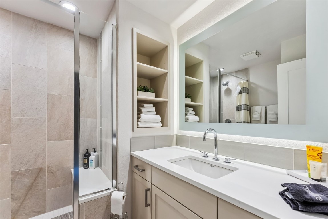 563 Bills Ranch Road Frisco, CO 80443 - Photo 23 of 50 Full bathroom featuring a stall shower, visible vents, vanity, and tasteful backsplash