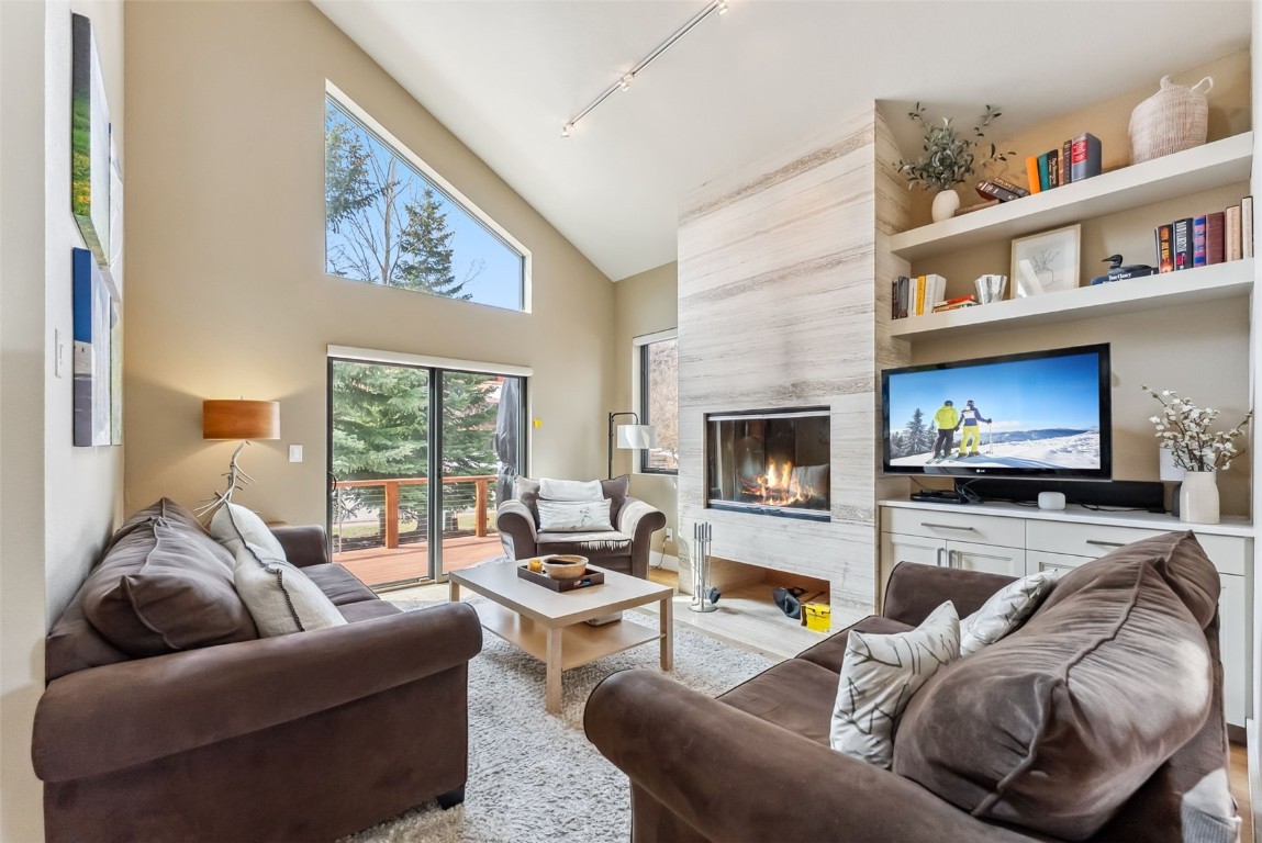 563 Bills Ranch Road Frisco, CO 80443 - Photo 5 of 50 Living room featuring track lighting, wood finished floors, a fireplace, and high vaulted ceiling