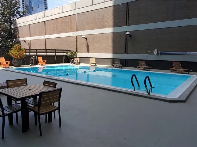 a view of a swimming pool with a chair and tables