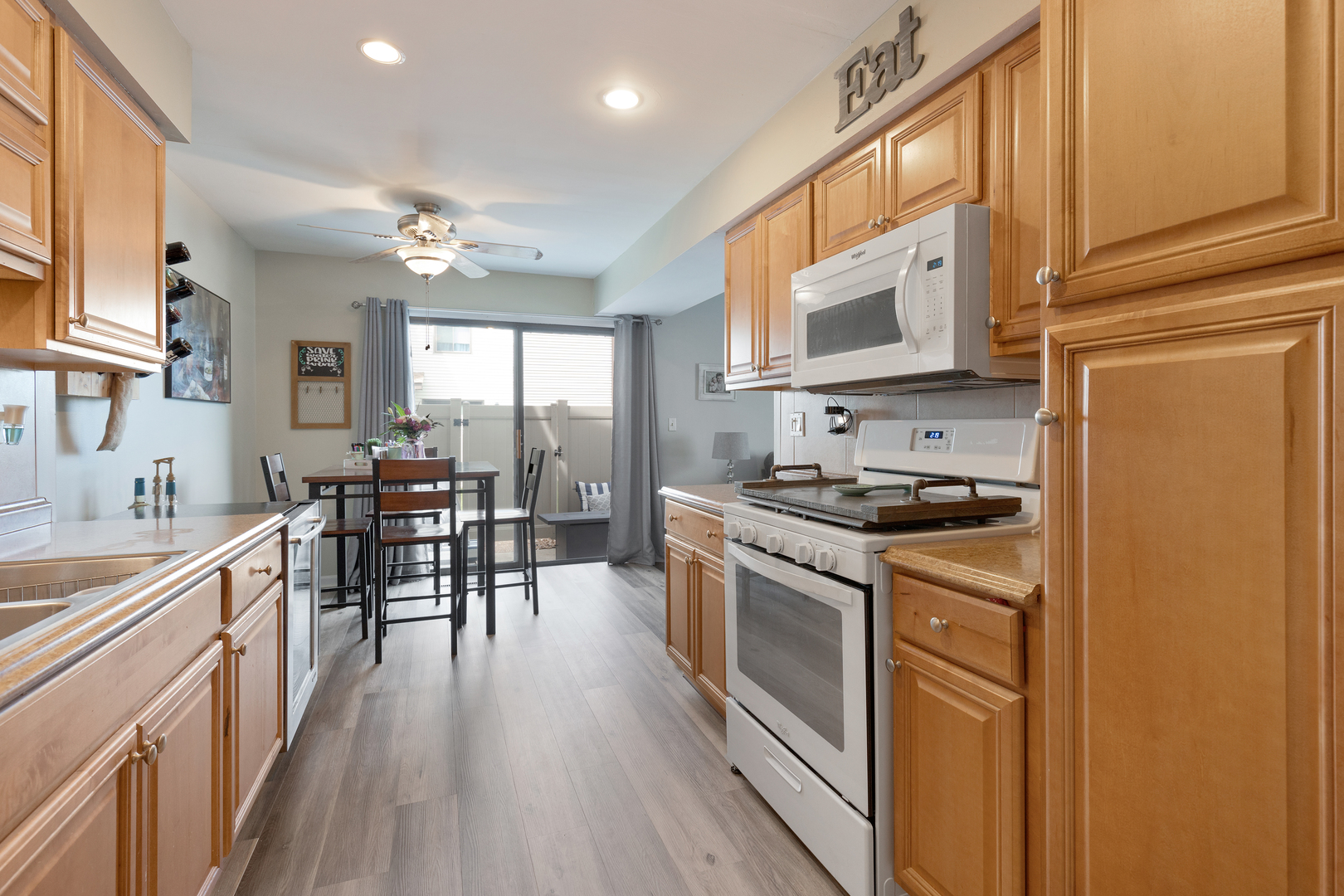 1065 Southgate Road New Lenox, IL 60451 - Photo 5 of 12 a kitchen with stainless steel appliances granite countertop hardwood floor sink stove dining table and chairs