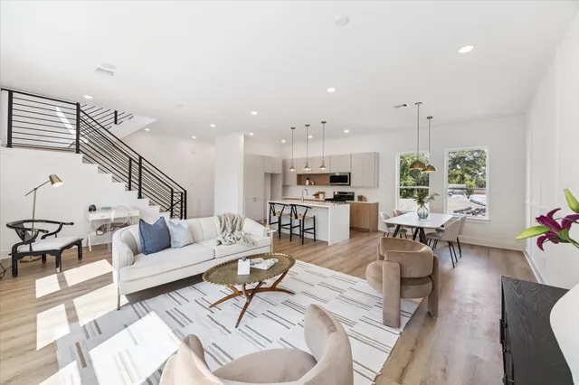 a living room with furniture and kitchen view