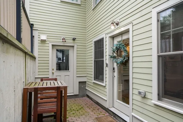 a view of a balcony with chairs and a potted plant