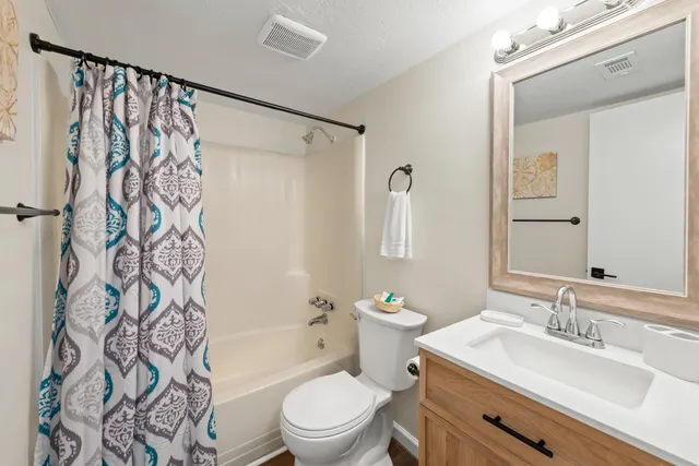 a bathroom with a sink a toilet and a bathtub