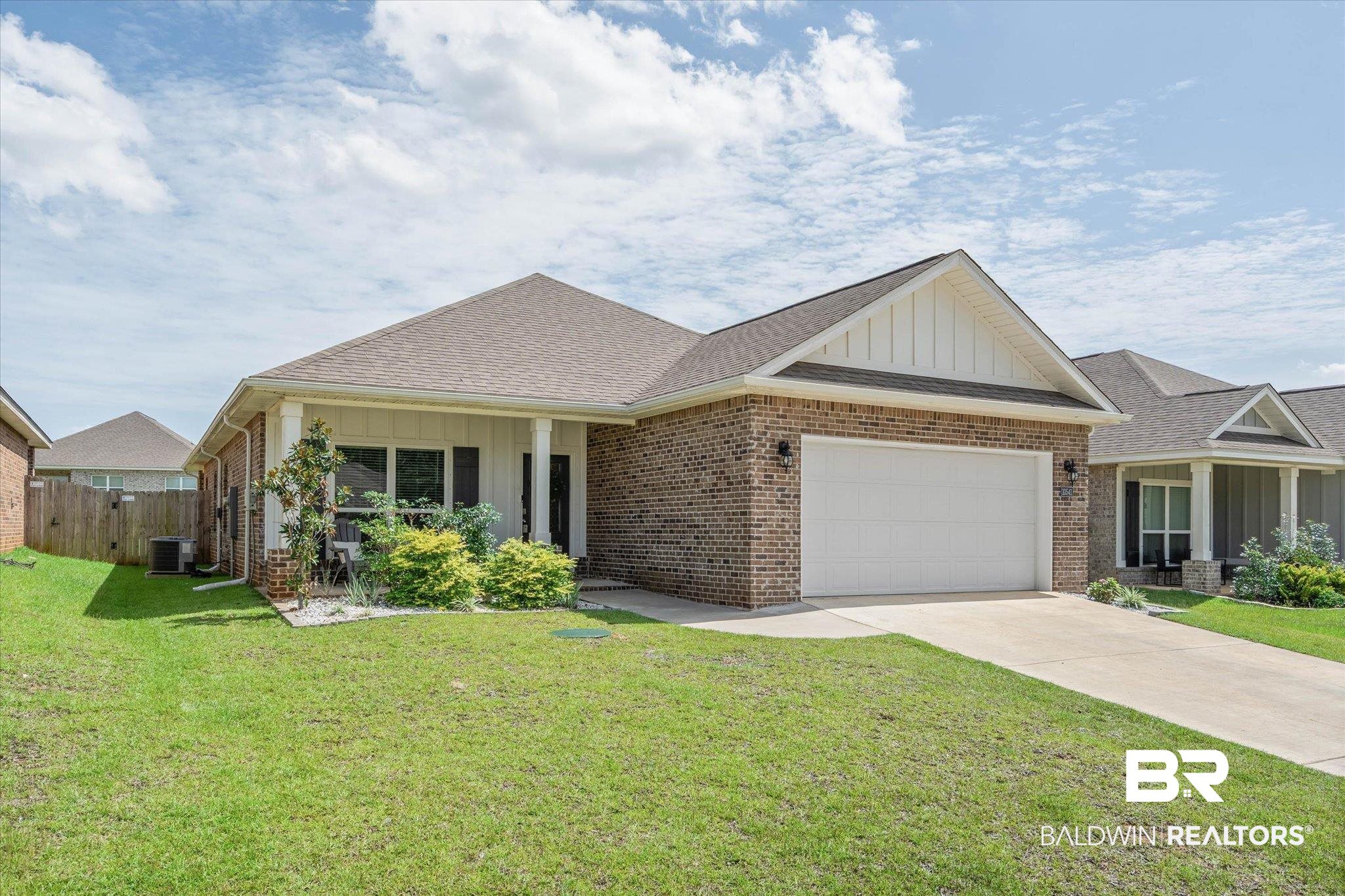 10541 Heirloom Road South Mobile, AL 36608 - Photo 20 of 23 Brick and siding exterior featuring a covered entry, attached two-car garage, and concrete driveway