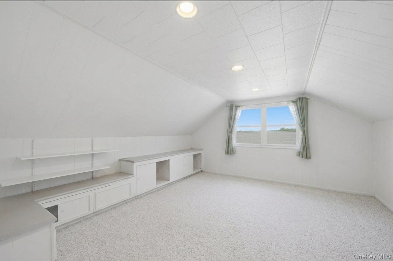 29 Montrose Road Yonkers, NY 10710 - Photo 17 of 39 Bright attic bedroom featuring light-toned carpeting, a window with distant scenery, and recessed lighting