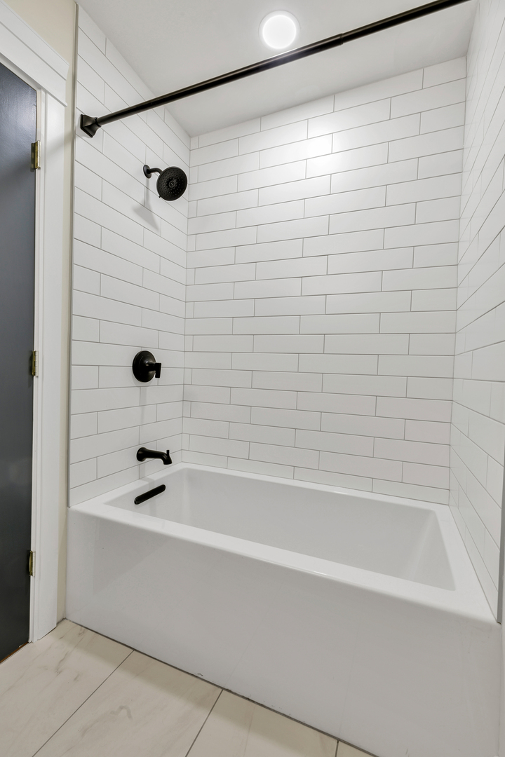 317 Canal Street, Unit B Lemont, IL 60439 - Photo 14 of 15 a bathroom with a shower and a bathtub