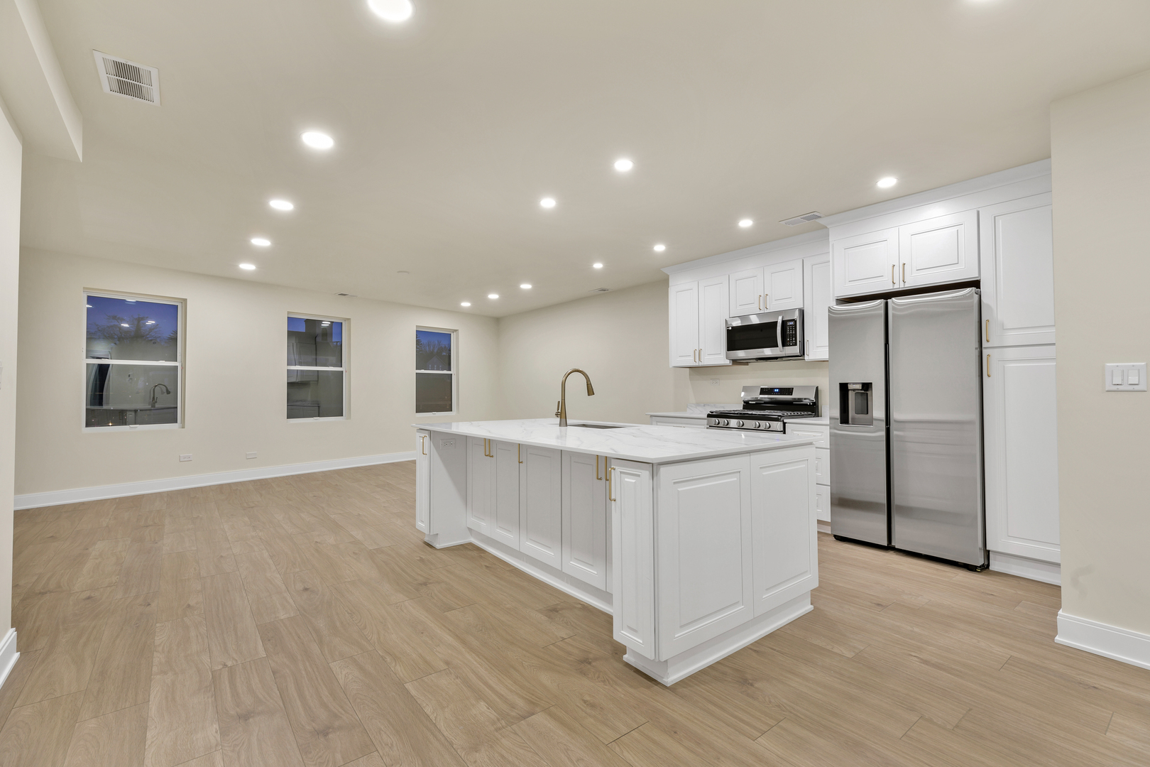 317 Canal Street, Unit B Lemont, IL 60439 - Photo 2 of 15 a kitchen with white cabinets and stainless steel appliances