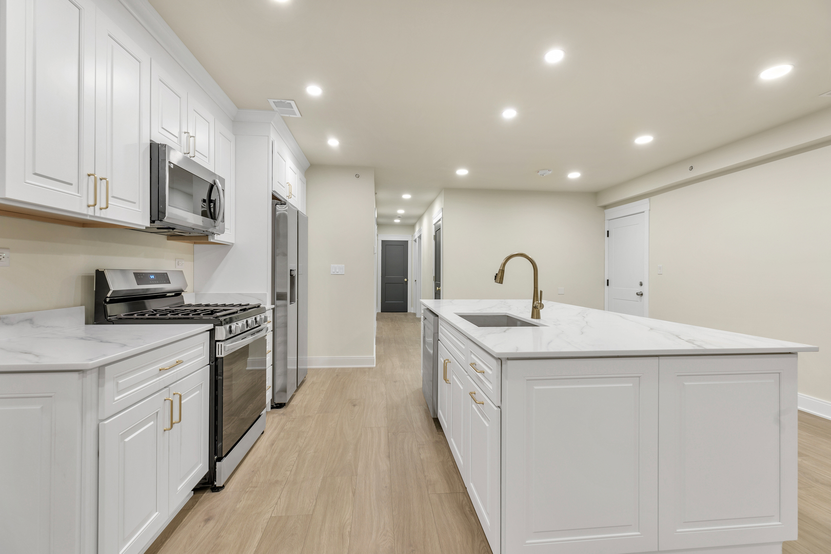 317 Canal Street, Unit B Lemont, IL 60439 - Photo 5 of 15 a kitchen with stainless steel appliances granite countertop a sink a stove and a refrigerator
