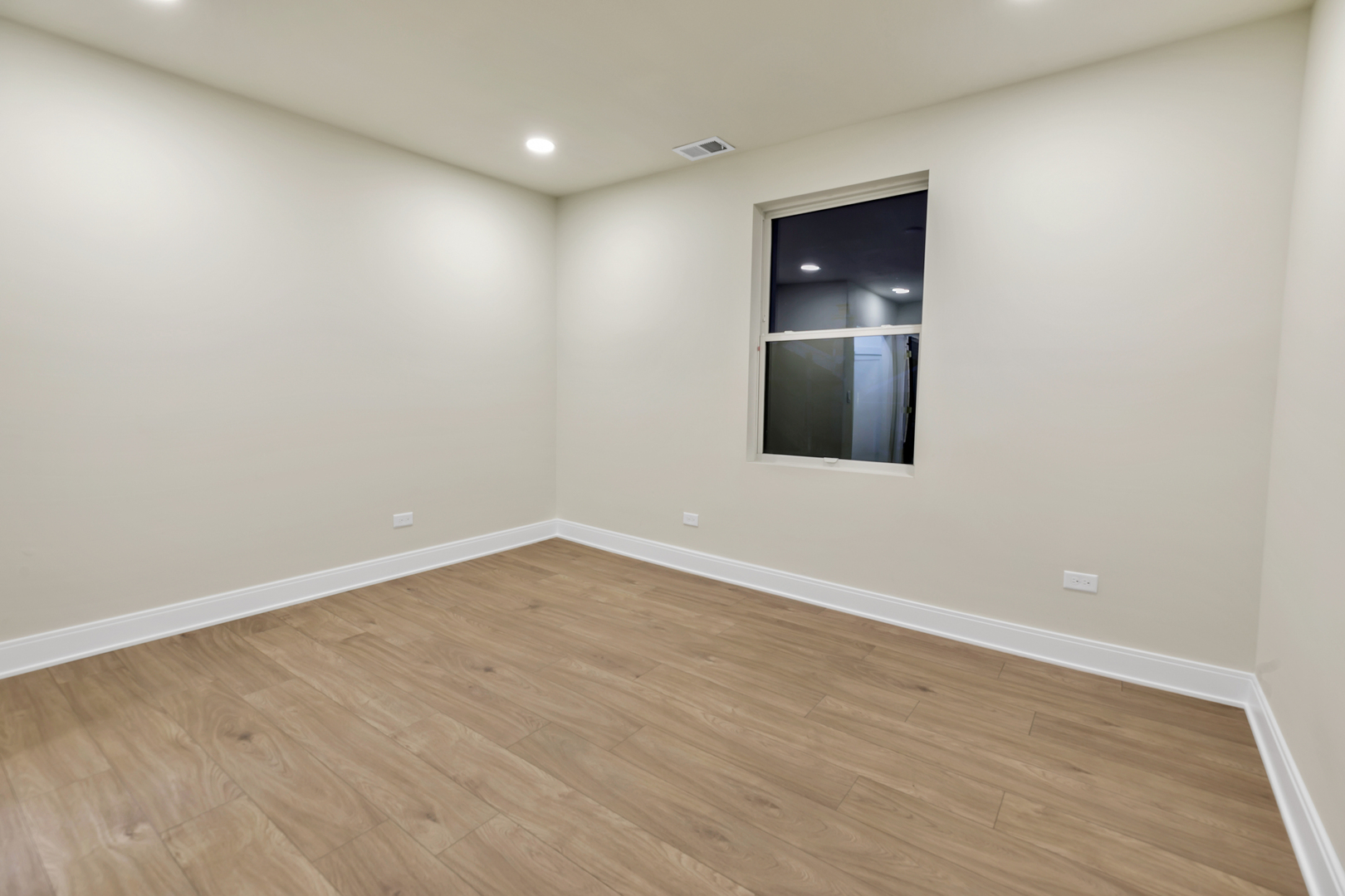 317 Canal Street, Unit B Lemont, IL 60439 - Photo 6 of 15 a view of an empty room with wooden floor and windows