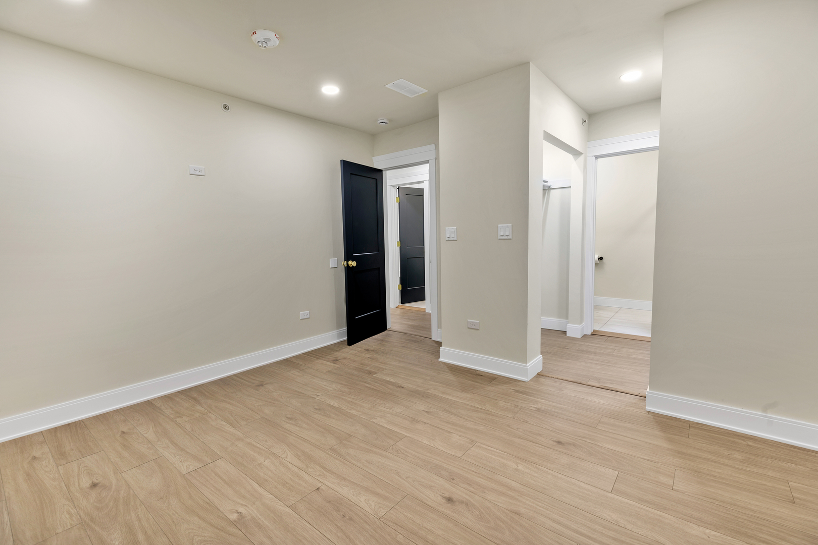 317 Canal Street, Unit B Lemont, IL 60439 - Photo 7 of 15 an empty room with wooden floor and windows