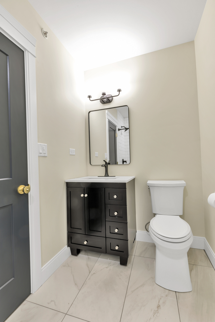 317 Canal Street, Unit B Lemont, IL 60439 - Photo 9 of 15 a bathroom with a toilet sink and mirror