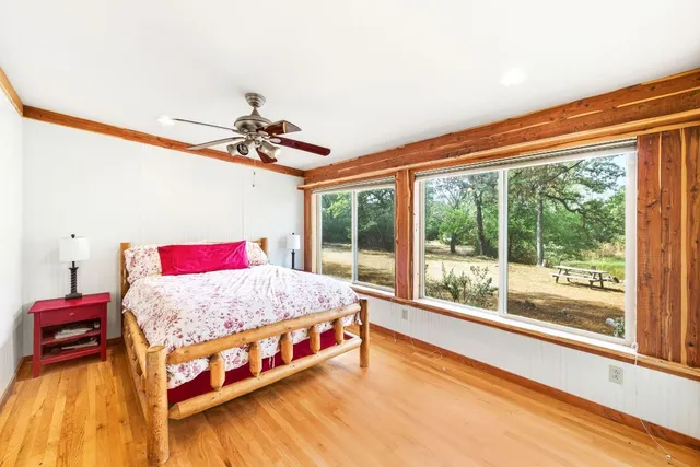 a bedroom with a bed and a large window