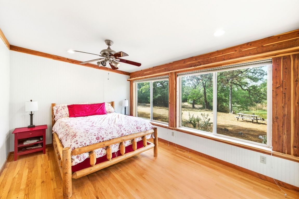 235 Antioch Road Paige, TX 78659 - Photo 15 of 40 a bedroom with a bed and a large window