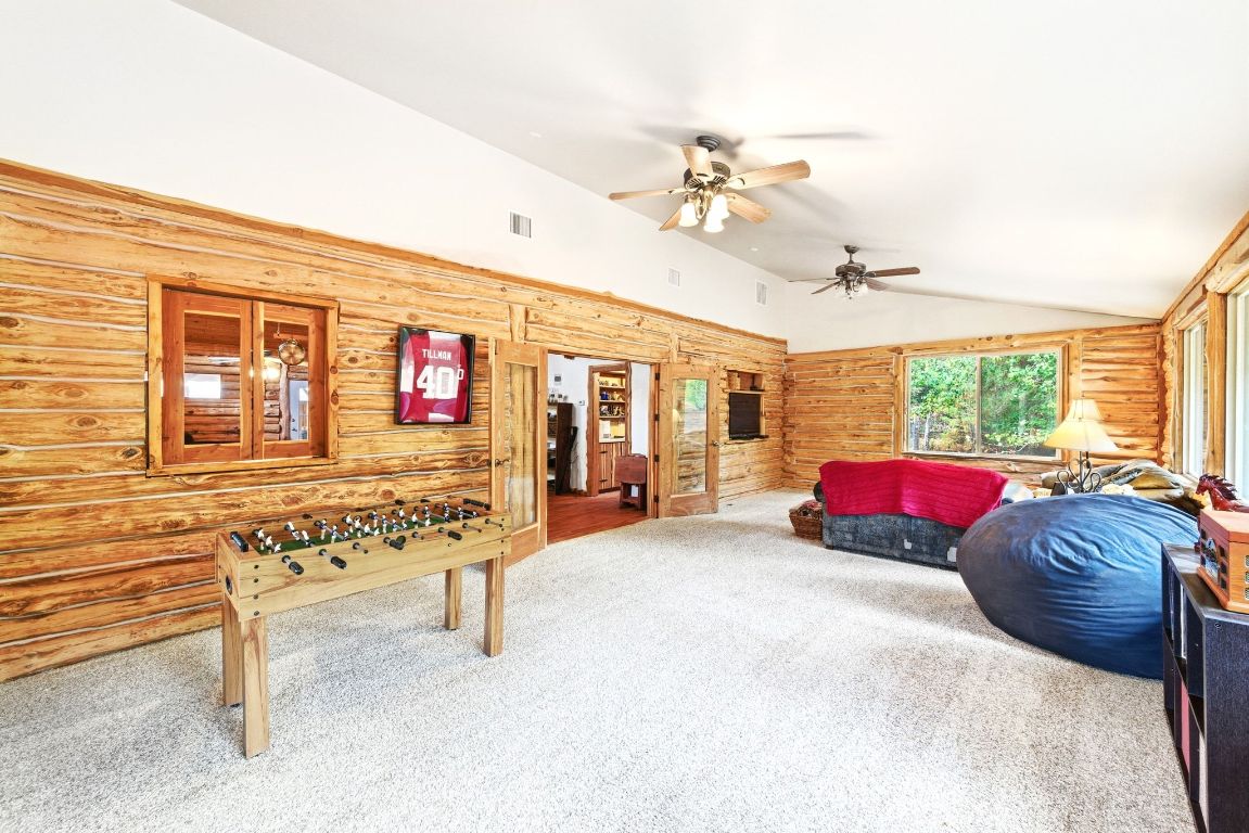 235 Antioch Road Paige, TX 78659 - Photo 20 of 40 a living room with furniture and a flat screen tv
