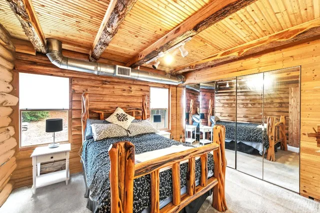 a bedroom with furniture and large windows