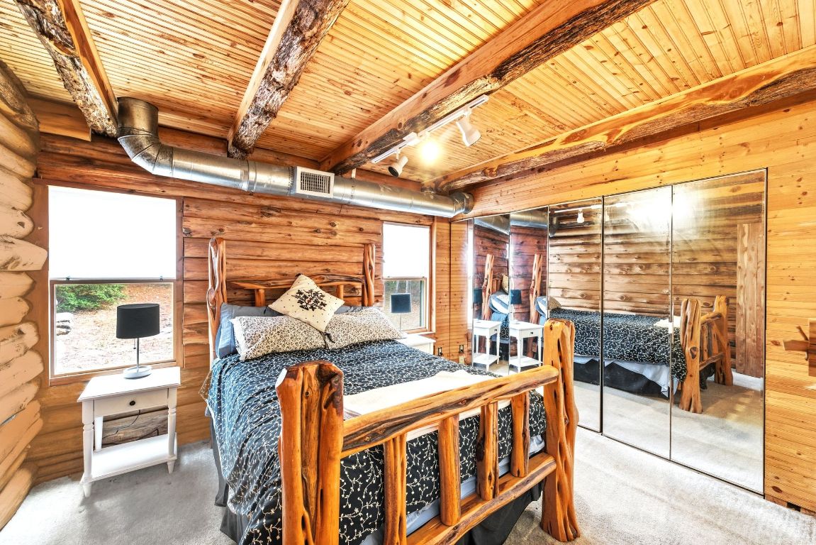 235 Antioch Road Paige, TX 78659 - Photo 22 of 40 a bedroom with furniture and large windows