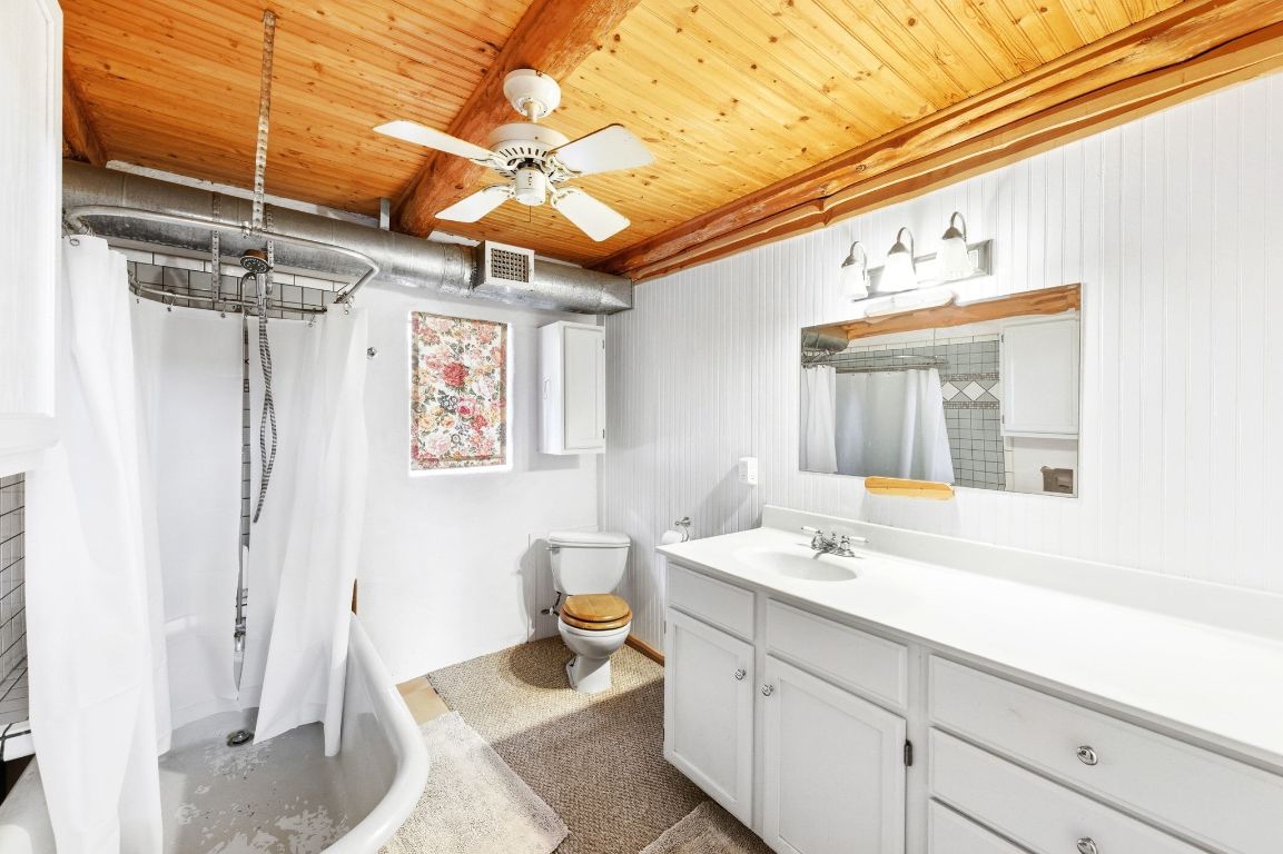 235 Antioch Road Paige, TX 78659 - Photo 23 of 40 a bathroom with a sink and mirror