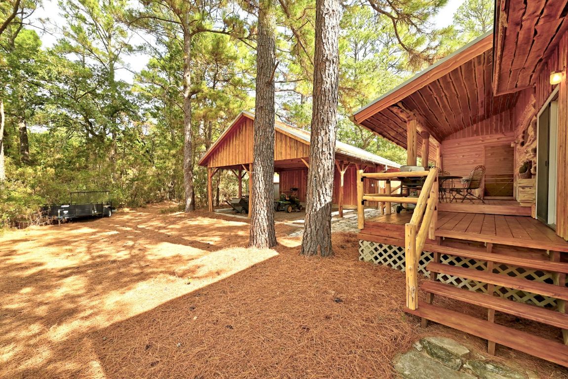235 Antioch Road Paige, TX 78659 - Photo 27 of 40 a backyard of a house with barbeque oven table and chairs