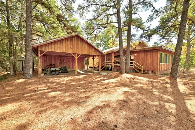 a view of a house with a yard covered in snow