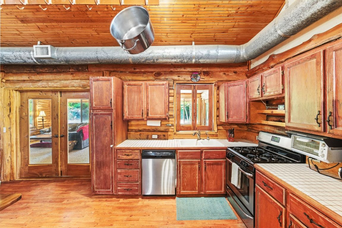 235 Antioch Road Paige, TX 78659 - Photo 10 of 40 a kitchen with a stove and cabinets