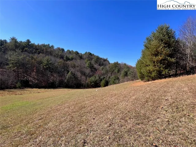 a view of mountain with wooden fence