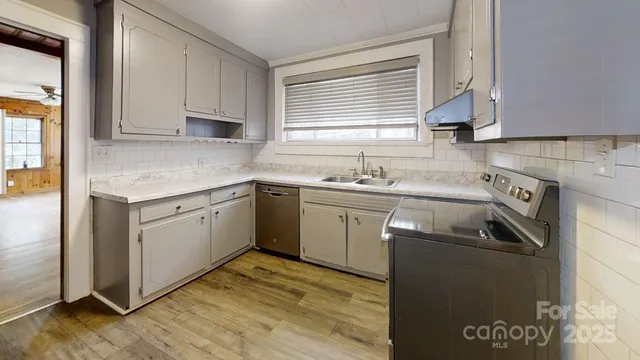 a kitchen with a sink stove and cabinets