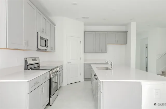 a utility room with cabinets washer and dryer
