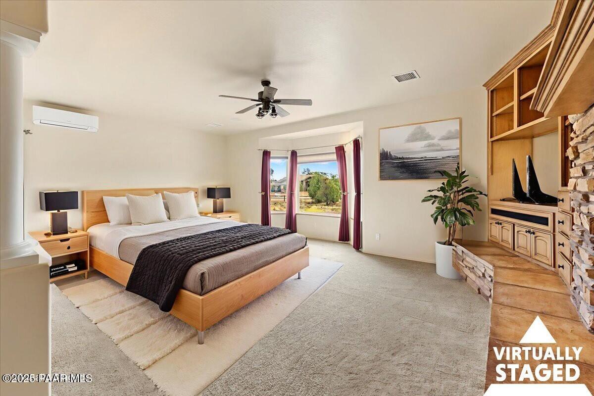 5540 Deer Spring Place Prescott, AZ 86305 - Photo 17 of 46 a bedroom with a bed and a chandelier