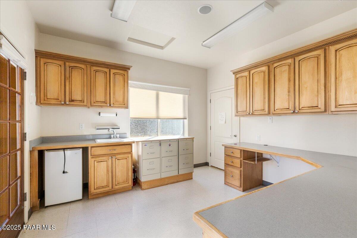 5540 Deer Spring Place Prescott, AZ 86305 - Photo 35 of 46 a kitchen with granite countertop a sink cabinets stainless steel appliances and a window