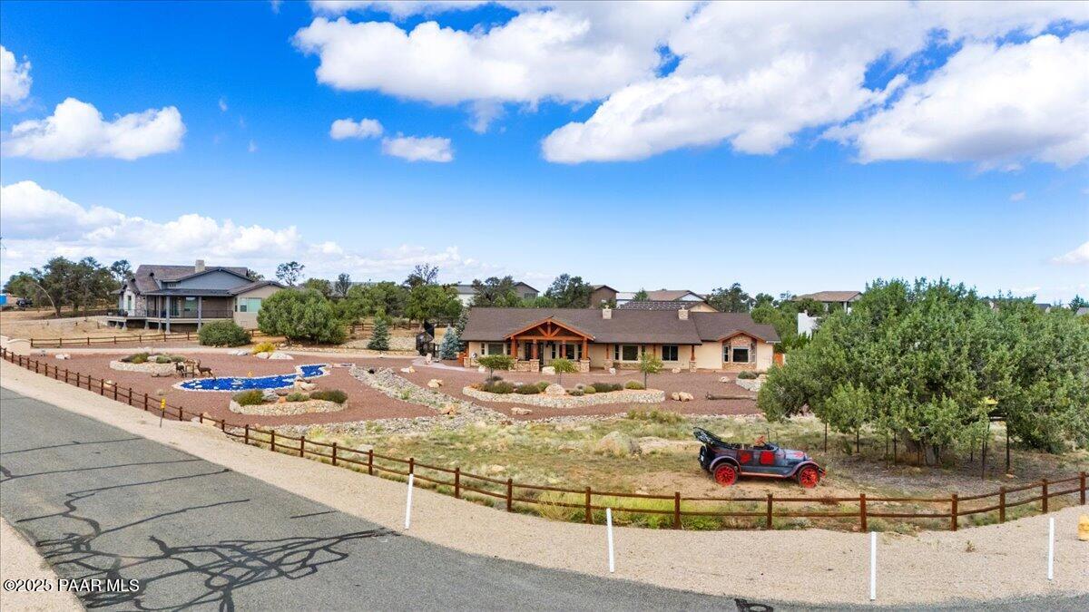 5540 Deer Spring Place Prescott, AZ 86305 - Photo 40 of 46 a large building with swimming pool and trees in the background