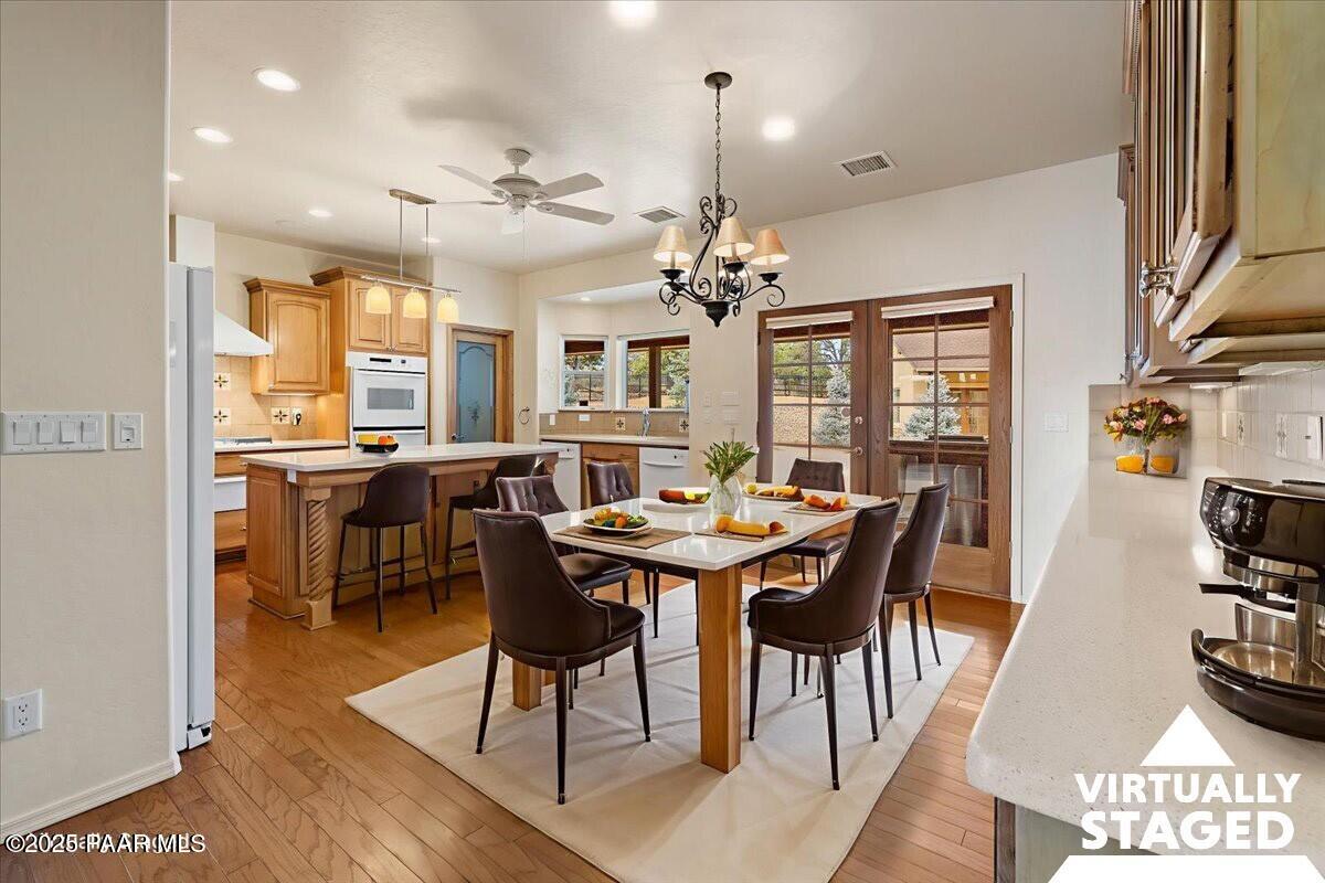5540 Deer Spring Place Prescott, AZ 86305 - Photo 8 of 46 a view of a dining room with furniture and a chandelier