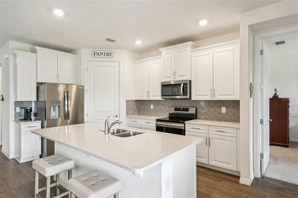 a kitchen with a white stove and white cabinets