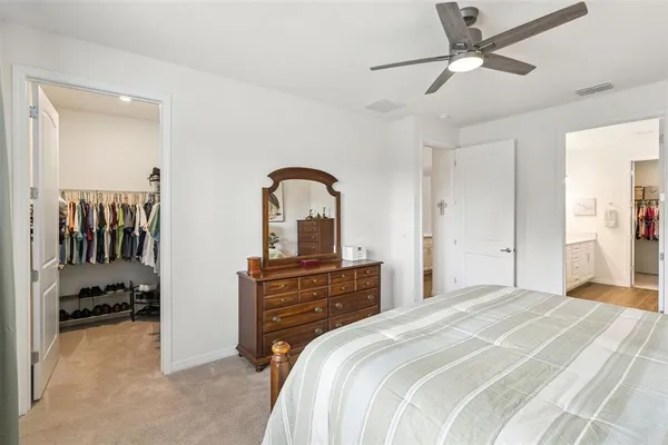 a view of walk in closet with clothes and shoes