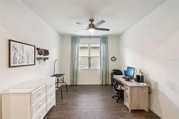 a view of a dining room with furniture and a potted plant