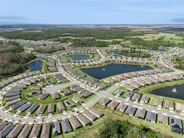 a kitchen with a refrigerator sink and wooden cabinets