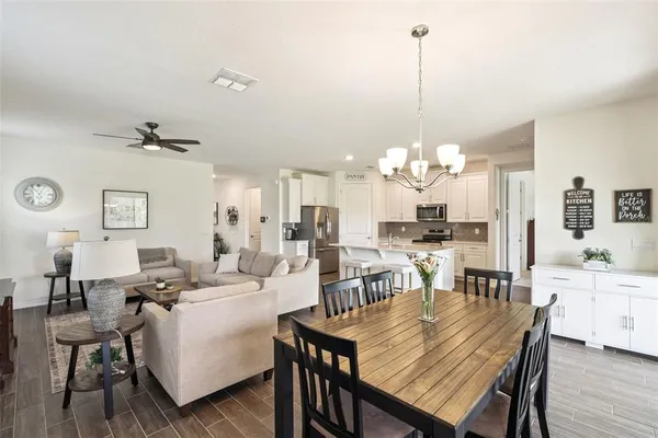 a dining room with furniture window and wooden floor