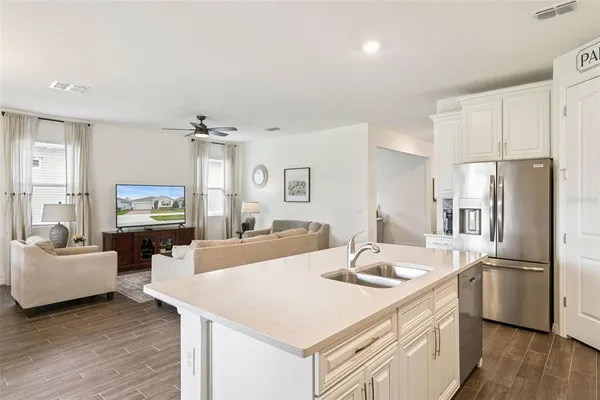 a kitchen that has a sink cabinets counter space and stainless steel appliances