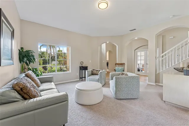 a living room with furniture and a large window