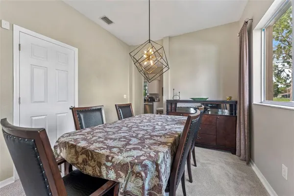a dining room with a table chairs and a chandelier