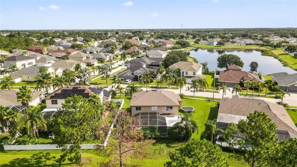 an aerial view of residential houses with outdoor space and swimming pool