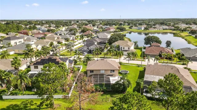 an aerial view of residential houses with outdoor space and swimming pool