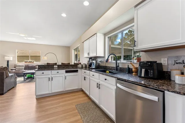 a kitchen with granite countertop lots of counter top space and stainless steel appliances
