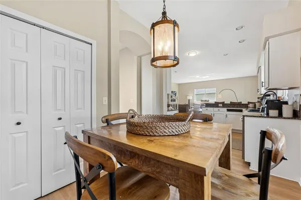 a dining room with furniture and a chandelier