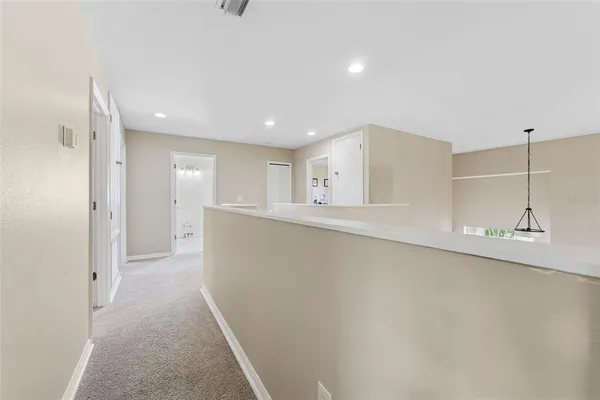 a spacious bedroom with a bed and a dresser