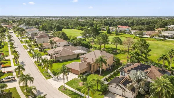 an aerial view of residential houses with outdoor space and river