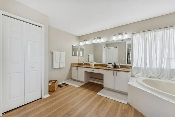 a bathroom with a tub shower and sink