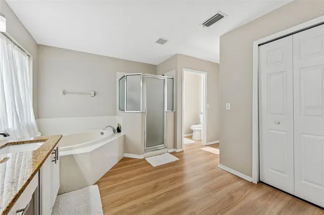 a view of walk in closet with clothes