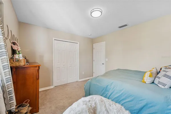 a bedroom with furniture and a baby crib