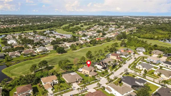 an aerial view of residential houses with outdoor space